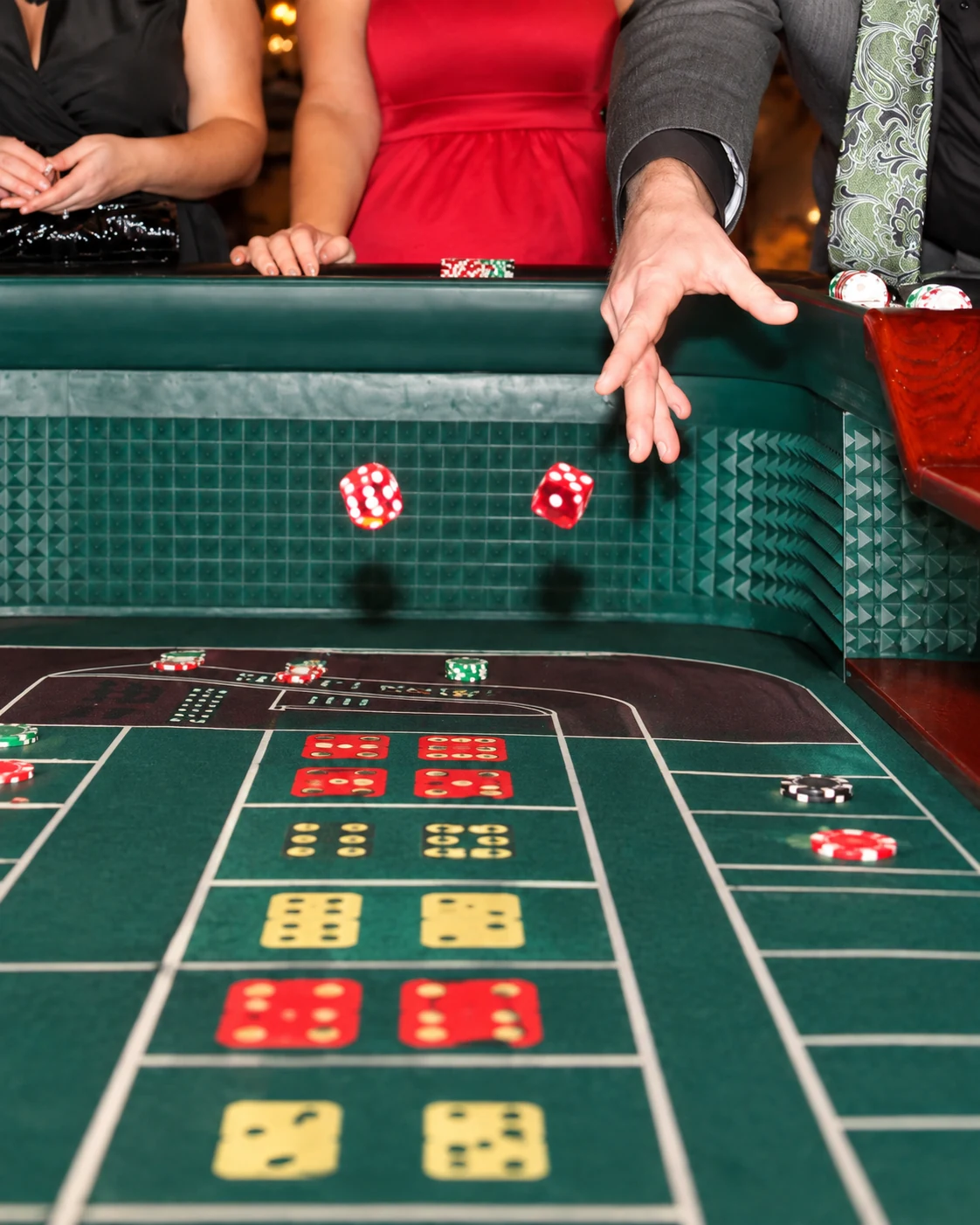 Craps dice in motion over the gaming table during an All Generations casino event.