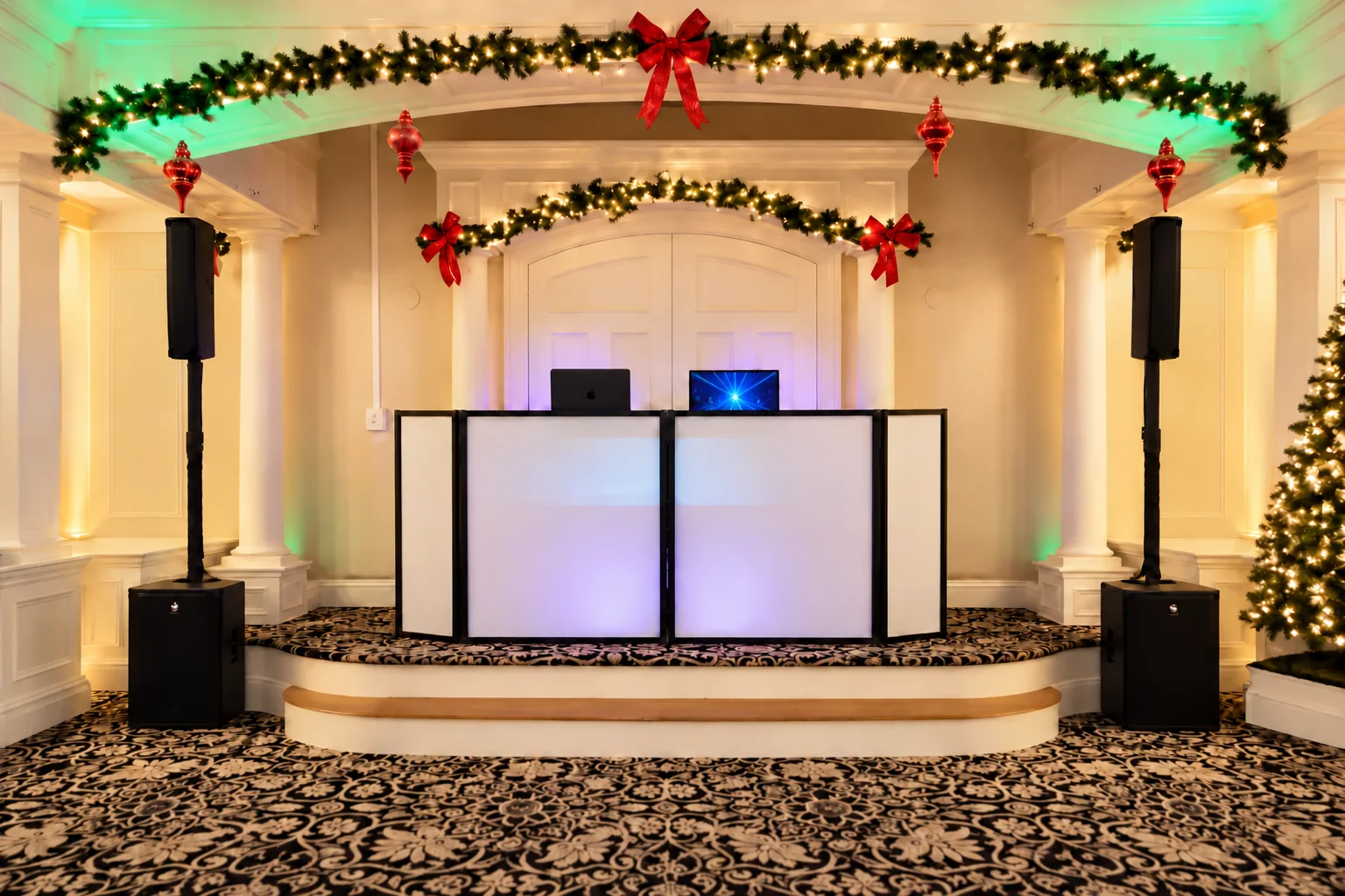 All Generations DJ setup beneath holiday garlands beside a lit Christmas tree.