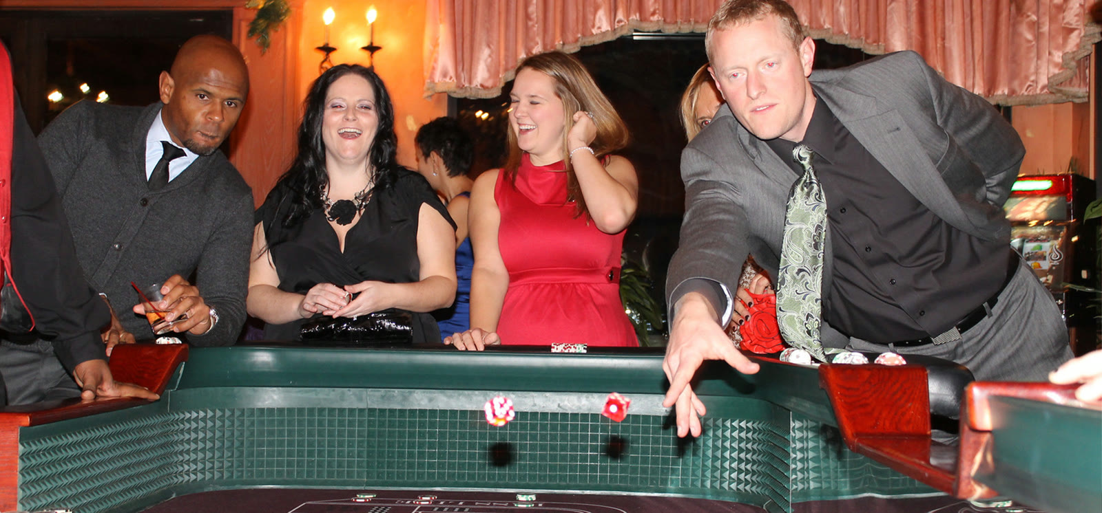 Guests enjoy a dealer-led casino table at an All Generations casino-night event.