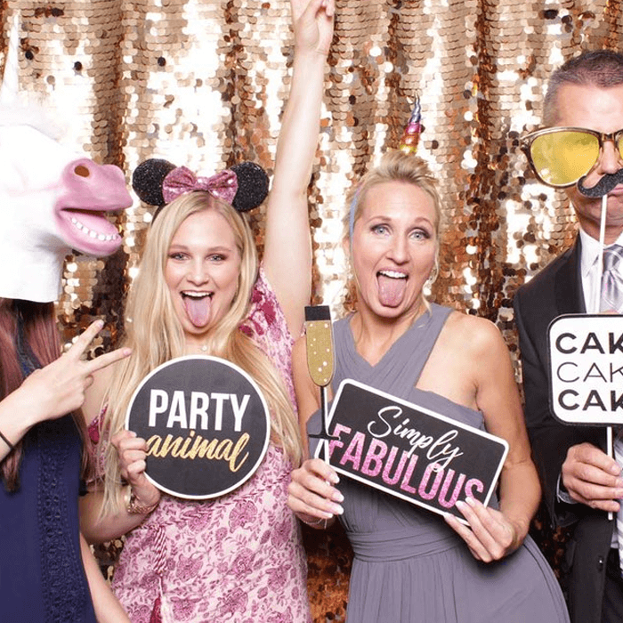 Guests actively using an All Generations photo booth experience.