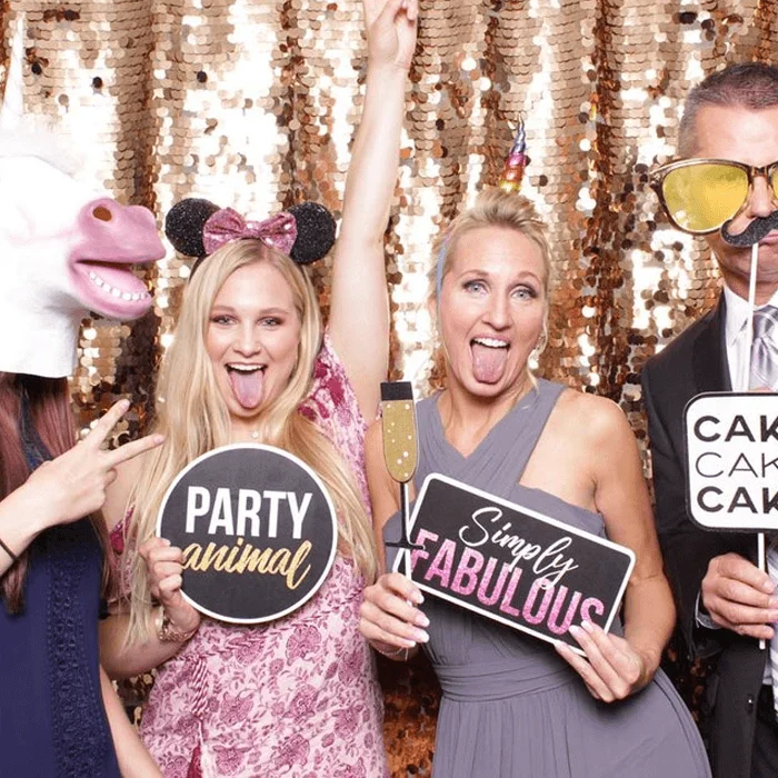 Guests pose with props at an All Generations photo booth.