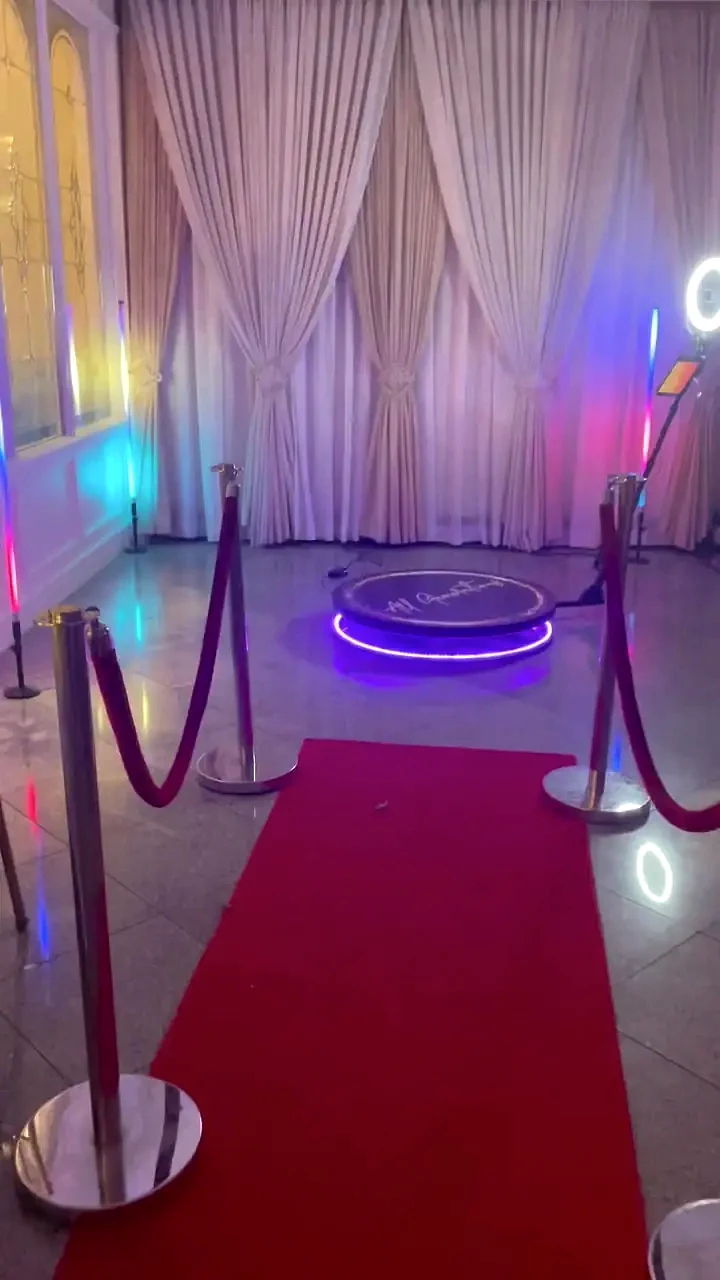 All Generations 360 video booth platform with red carpet and guest-area lighting.